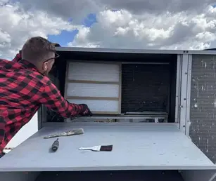 Technician performing HVAC maintenance on a residential system in Lake in the Hills, McHenry County, IL